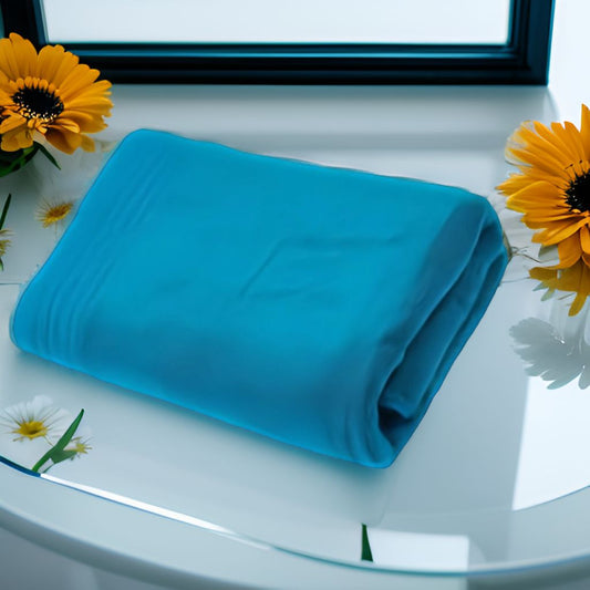 serviette de bain bleu poser sur une table en verre